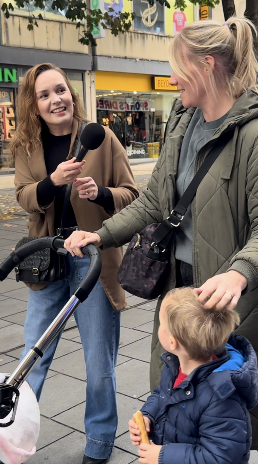 Gosia interviewing a mother on a UK high street